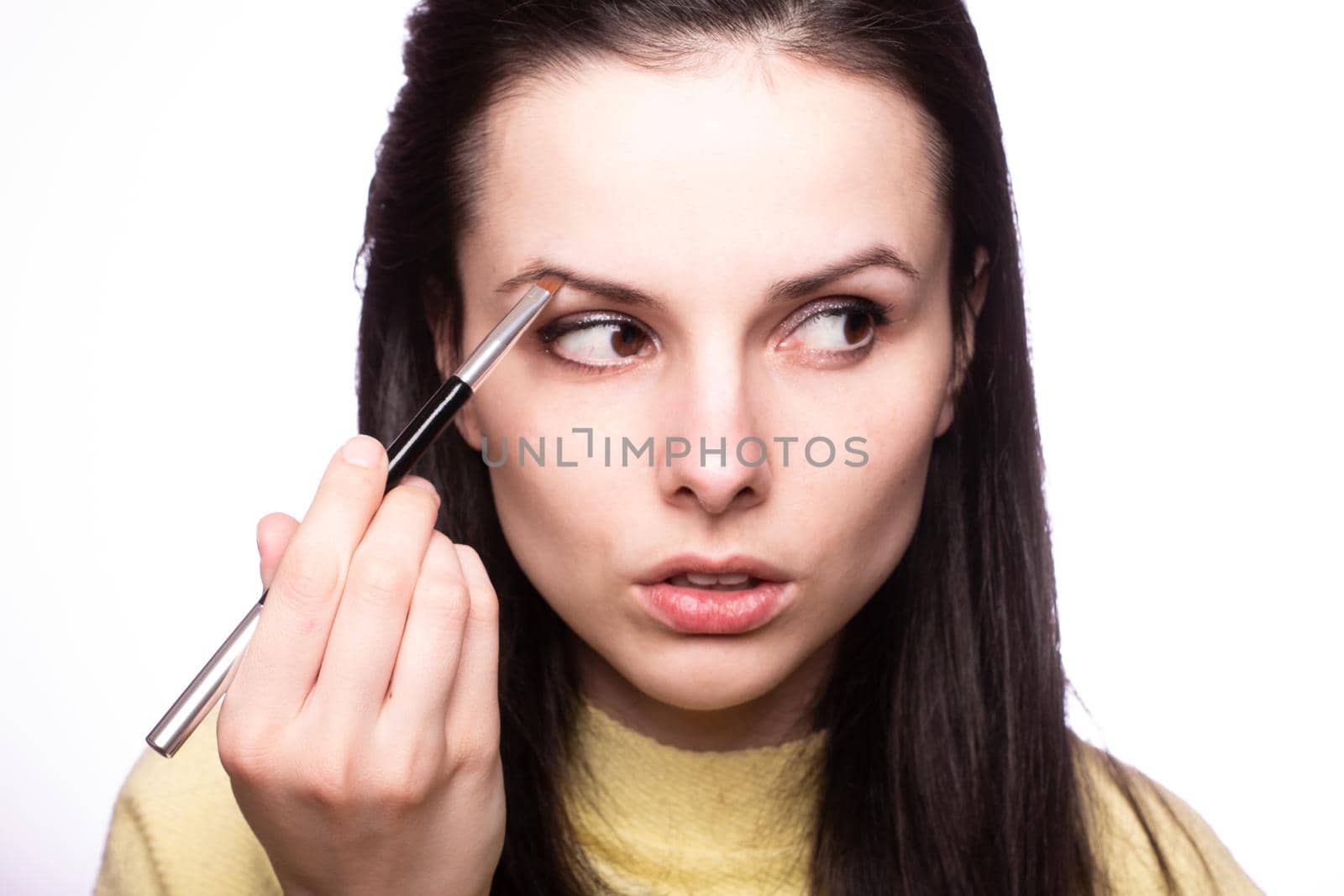 attractive young woman doing makeup by shilovskaya