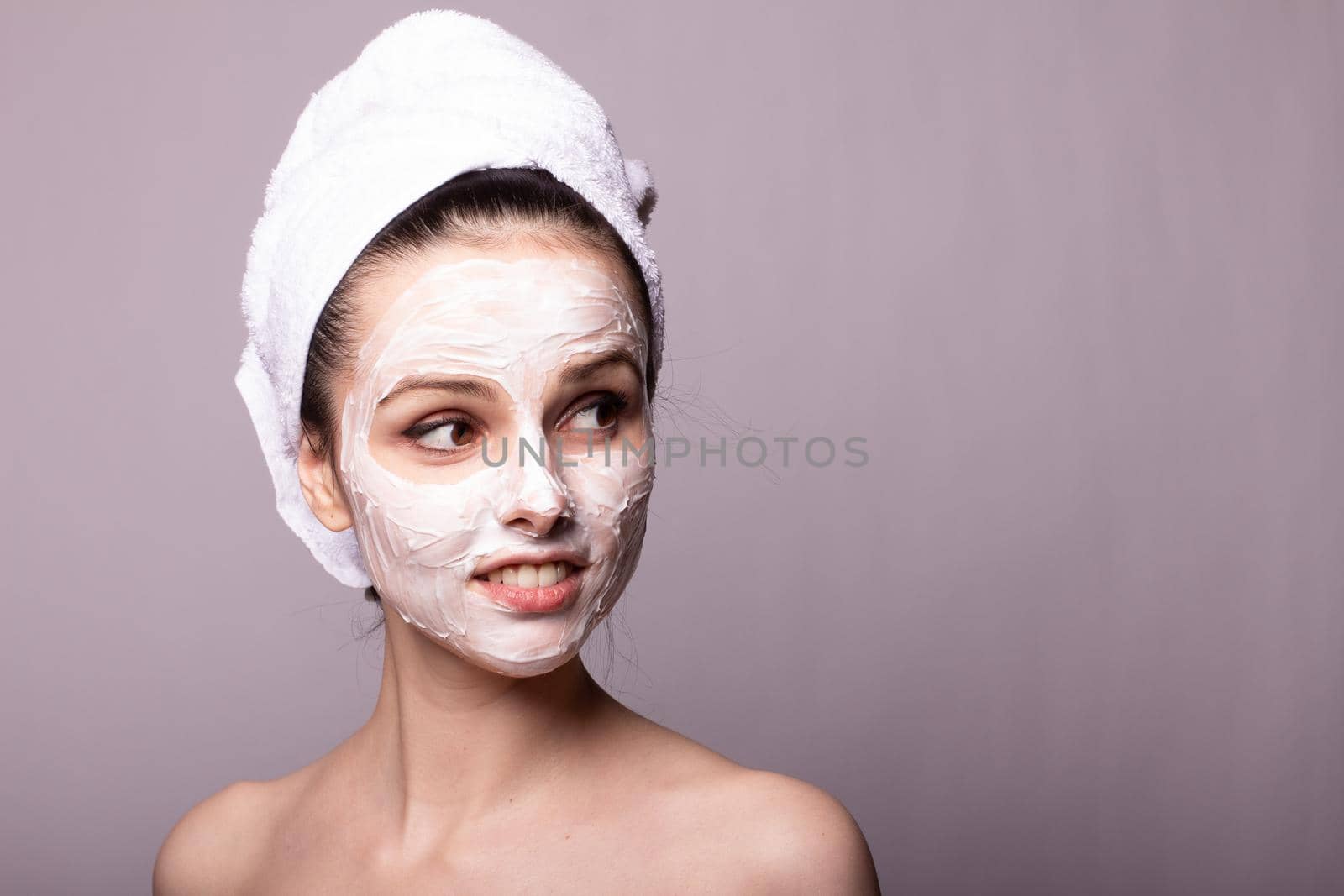 cute brunette woman in a yellow sweater holds a cosmetic sponge in her hands by shilovskaya