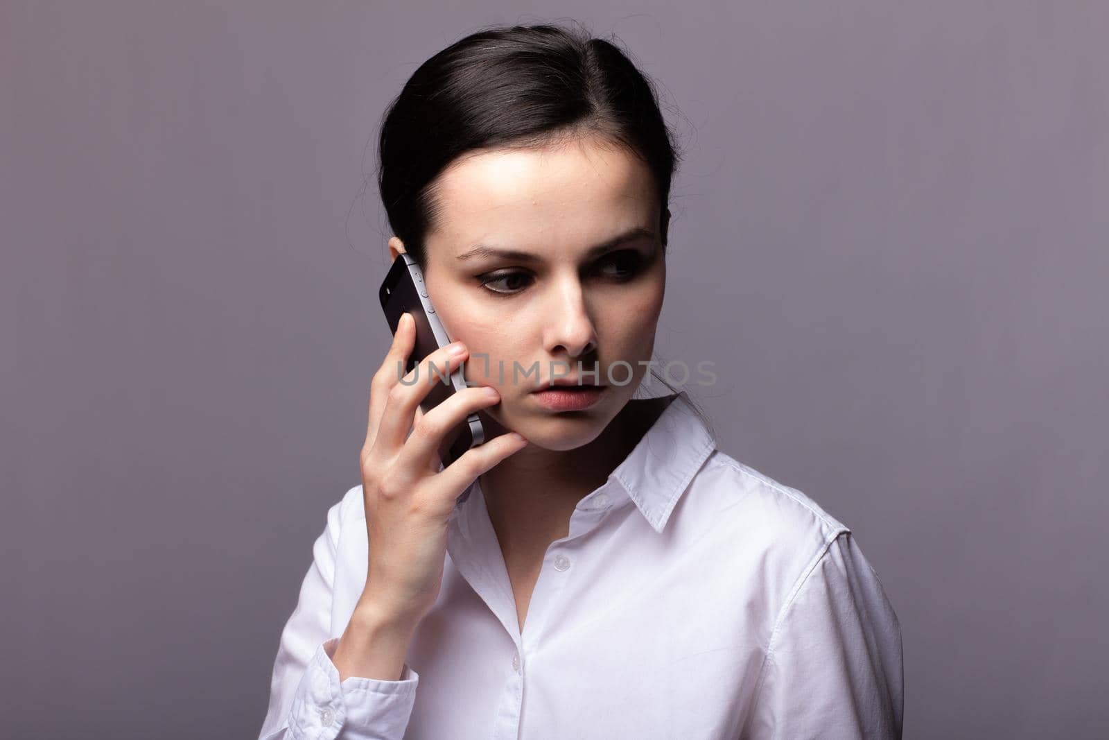 woman in a white shirt communicates on the phone. High quality photo