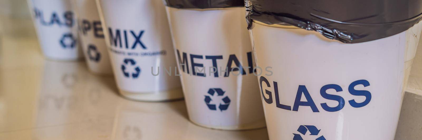 Garbage cans. Trash bins with sorted garbage in kitchen cabinet with segregated household garbage - plastic, paper, metal, glass. Ecology and recycle concept. BANNER, LONG FORMAT