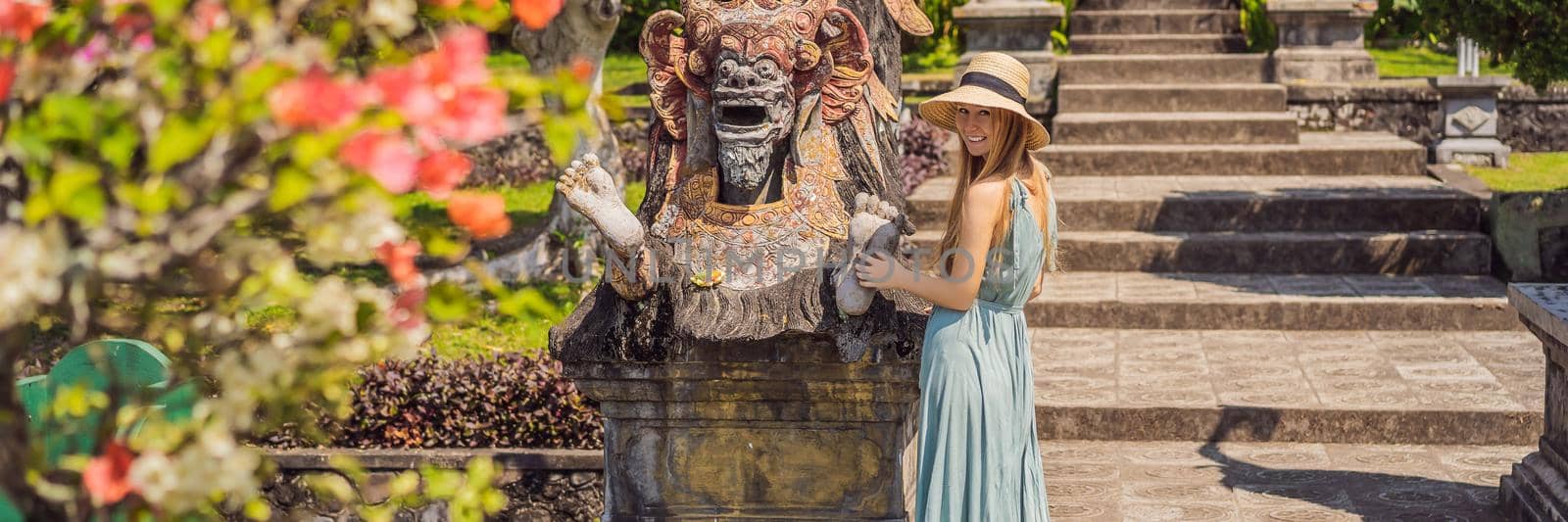 Young woman tourist in Taman Tirtagangga, Water palace, Water park, Bali Indonesia BANNER, LONG FORMAT by galitskaya