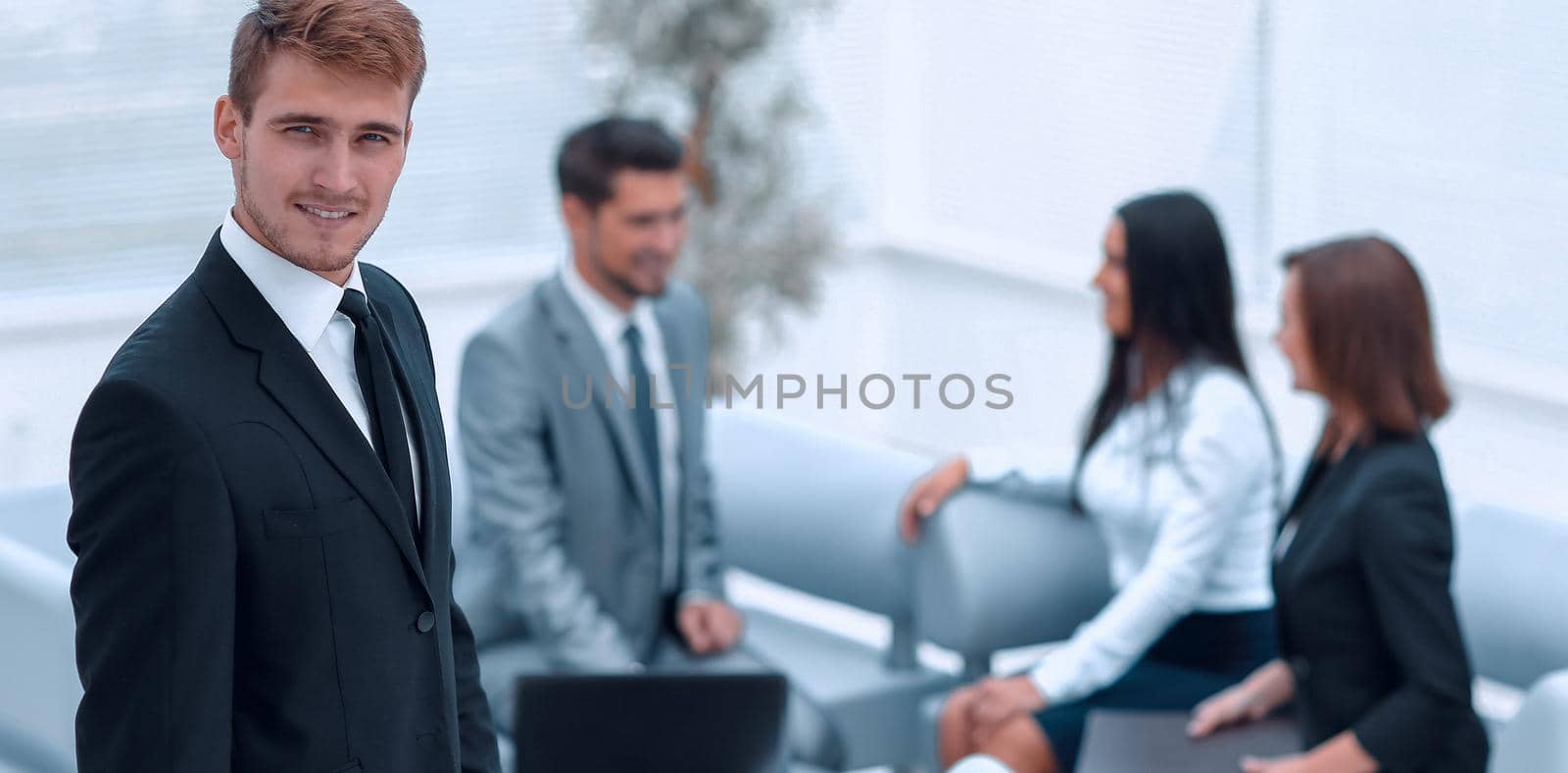 portrait of confident businessman on background of office. photo with copy space