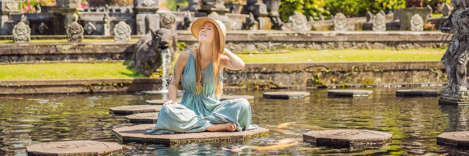 Young woman tourist in Taman Tirtagangga, Water palace, Water park, Bali Indonesia BANNER, LONG FORMAT by galitskaya