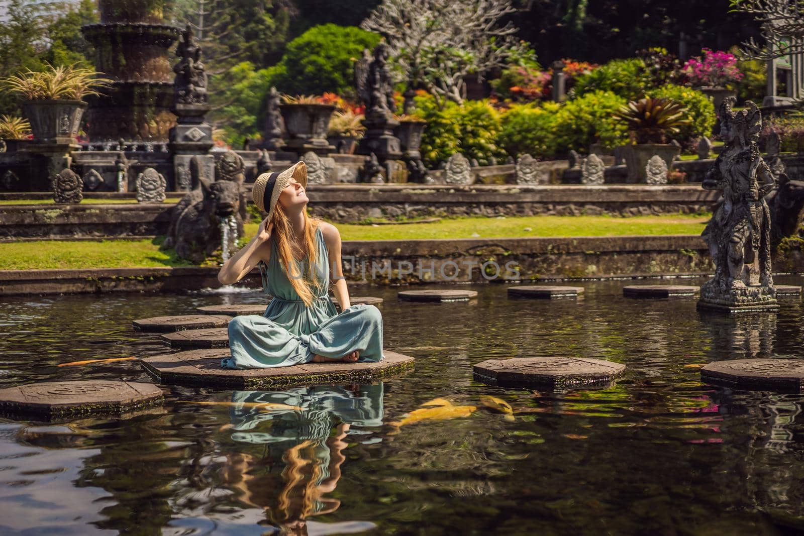 Young woman tourist in Taman Tirtagangga, Water palace, Water park, Bali Indonesia.