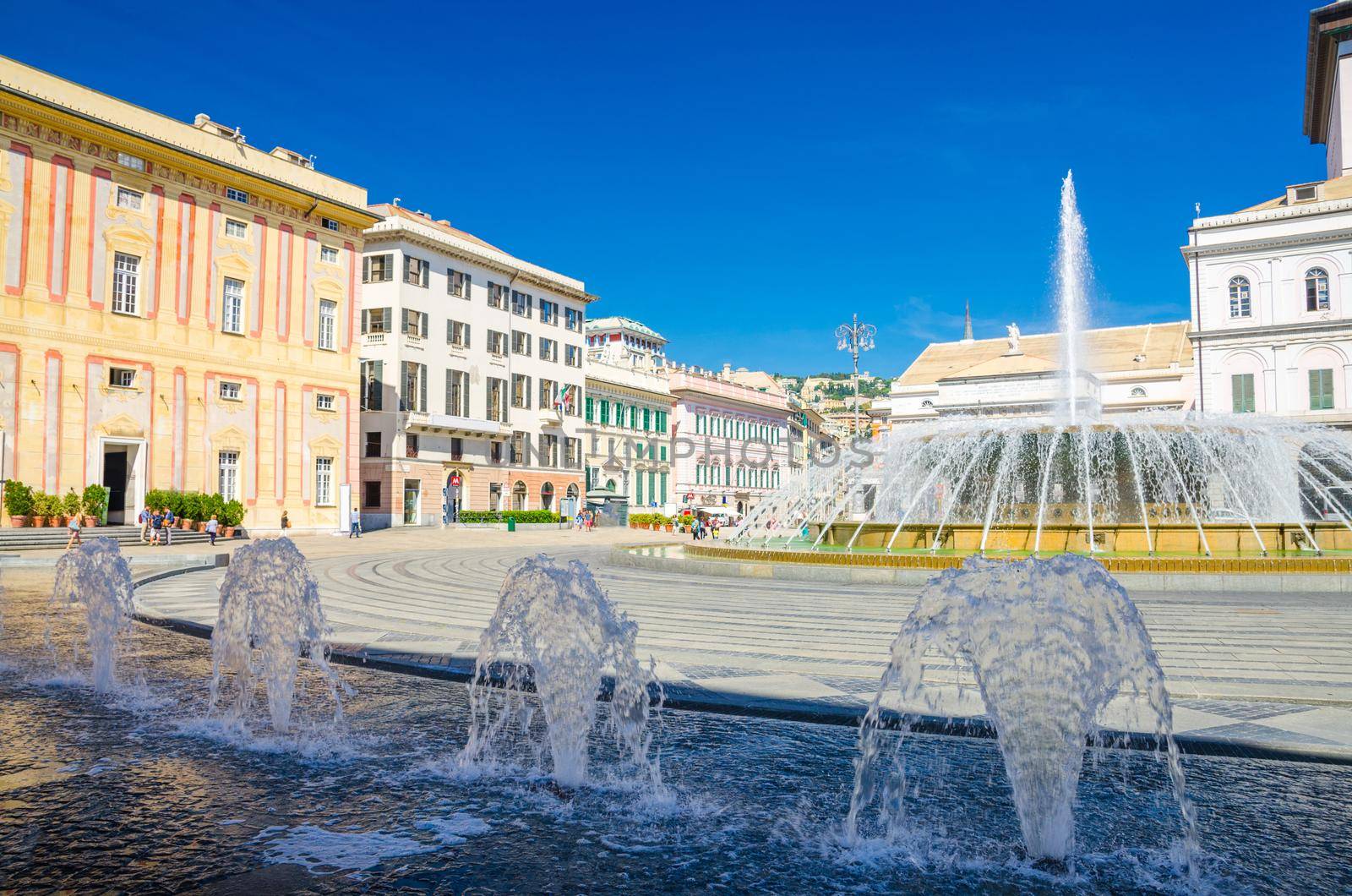 Piazza Raffaele De Ferrari square with fountain, Palazzo Ducale Doge's Palace and Teatro Carlo Felice theatre building in historical centre of old city Genoa Genova with blue sky, Liguria, Italy