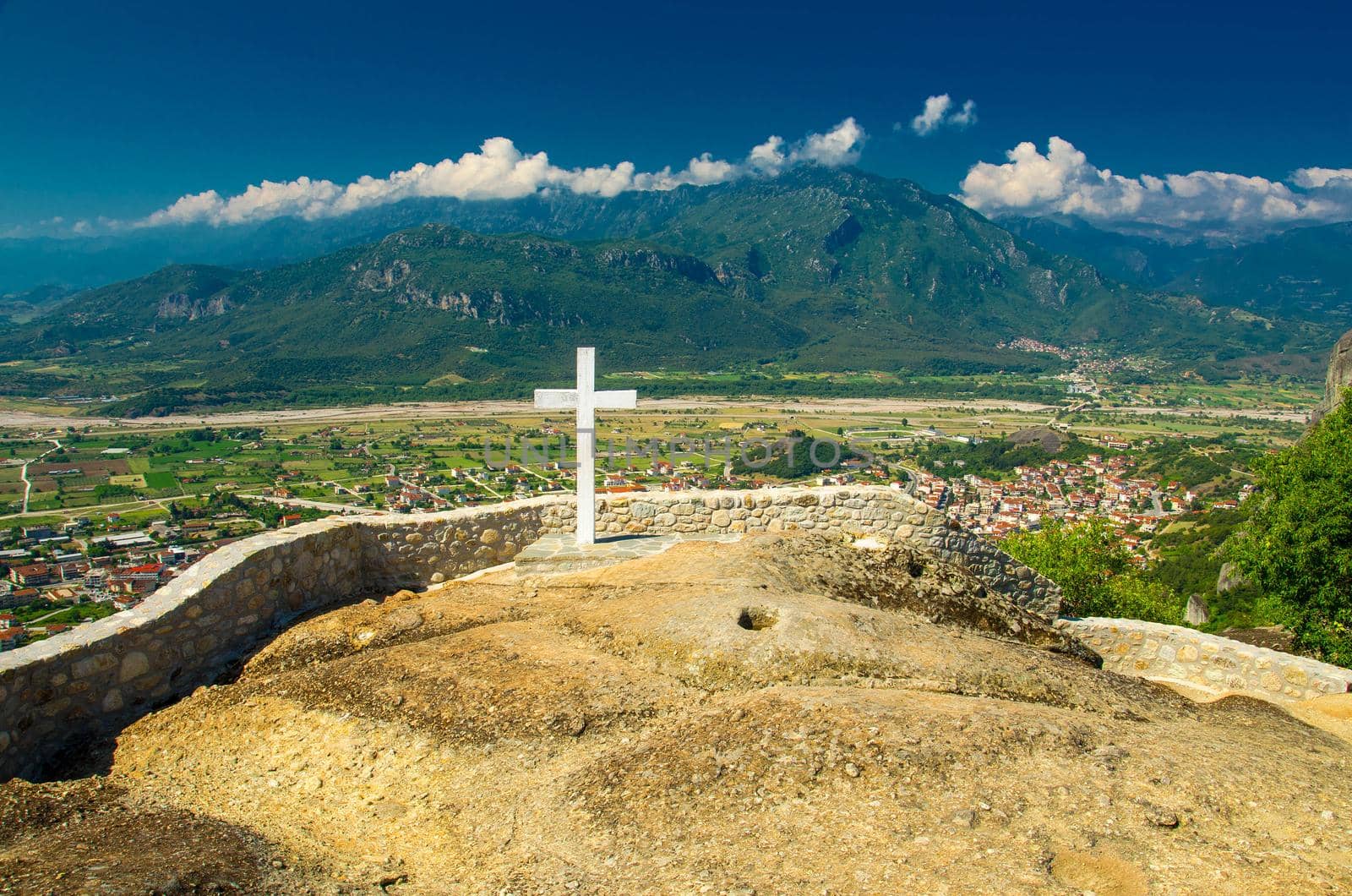 Big white cross of Holy Trinity Monastery (Meteora Monasteries) on the top of rock near Kalabaka, Greece