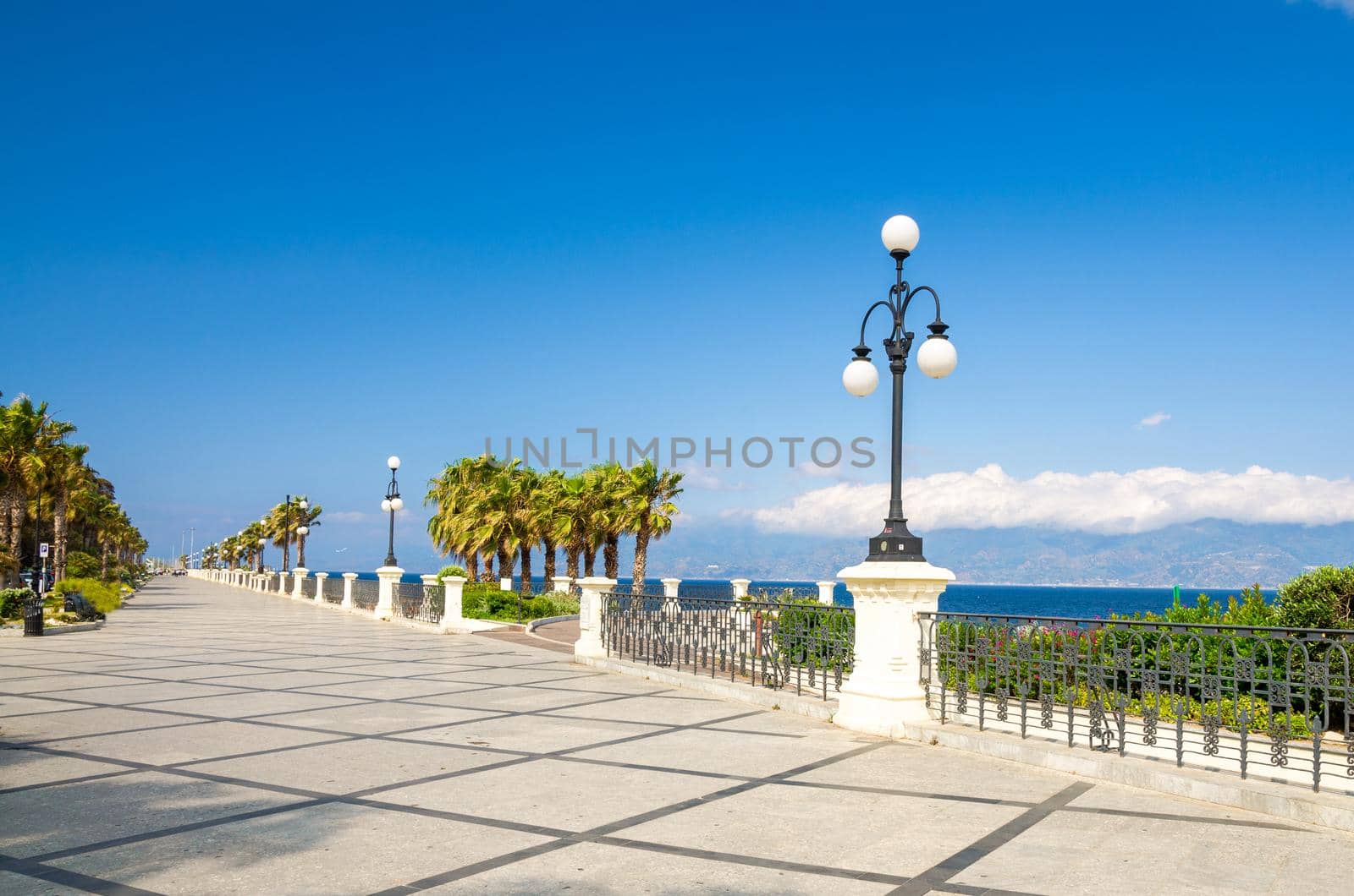 Reggio di Calabria quay waterfront promenade Lungomare Falcomata with view of Strait of Messina connected Mediterranean and Tyrrhenian sea and Sicilia island background, Southern Italy