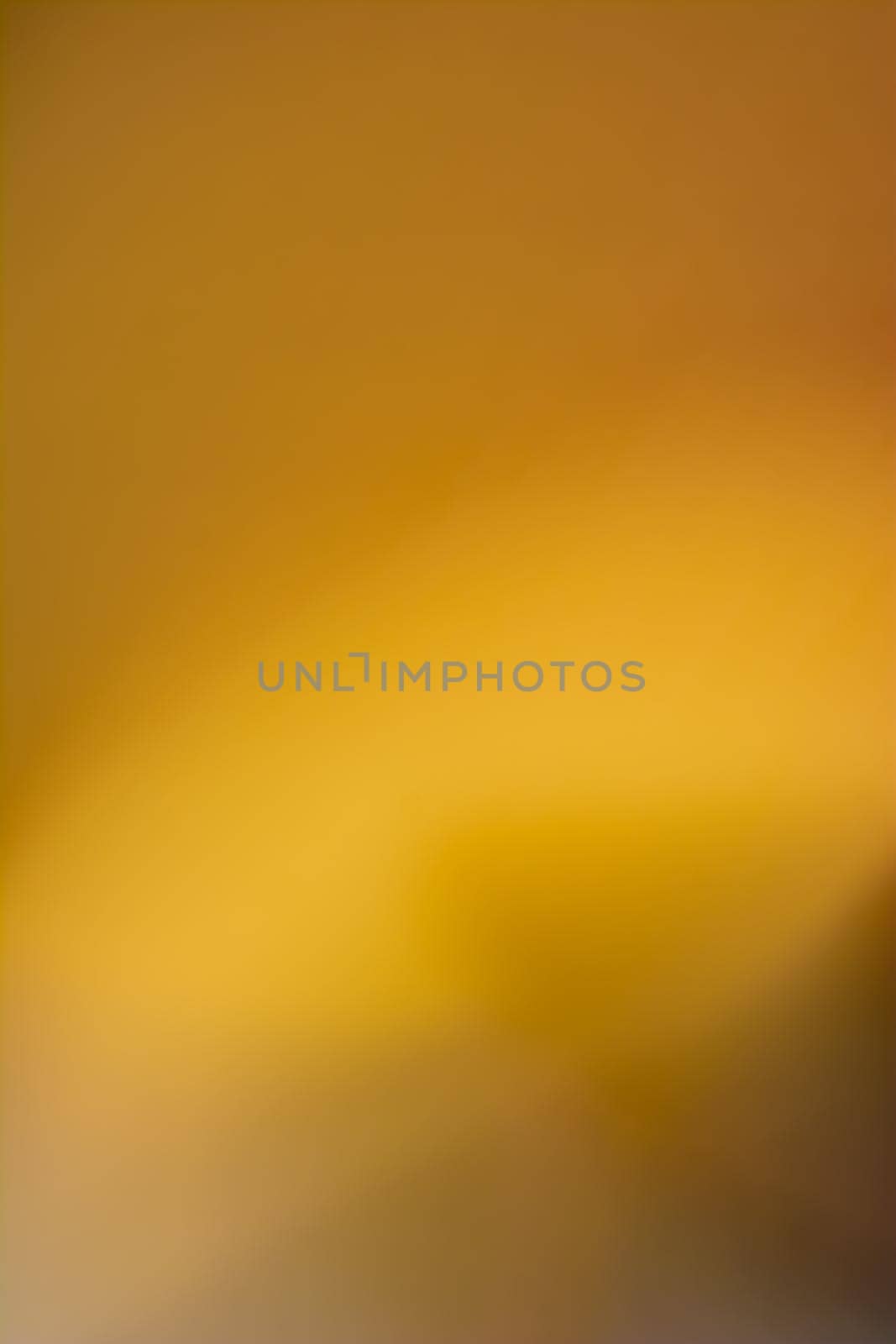 Dark yellow vertical background with bright highlights. Abstraction. Backdrop