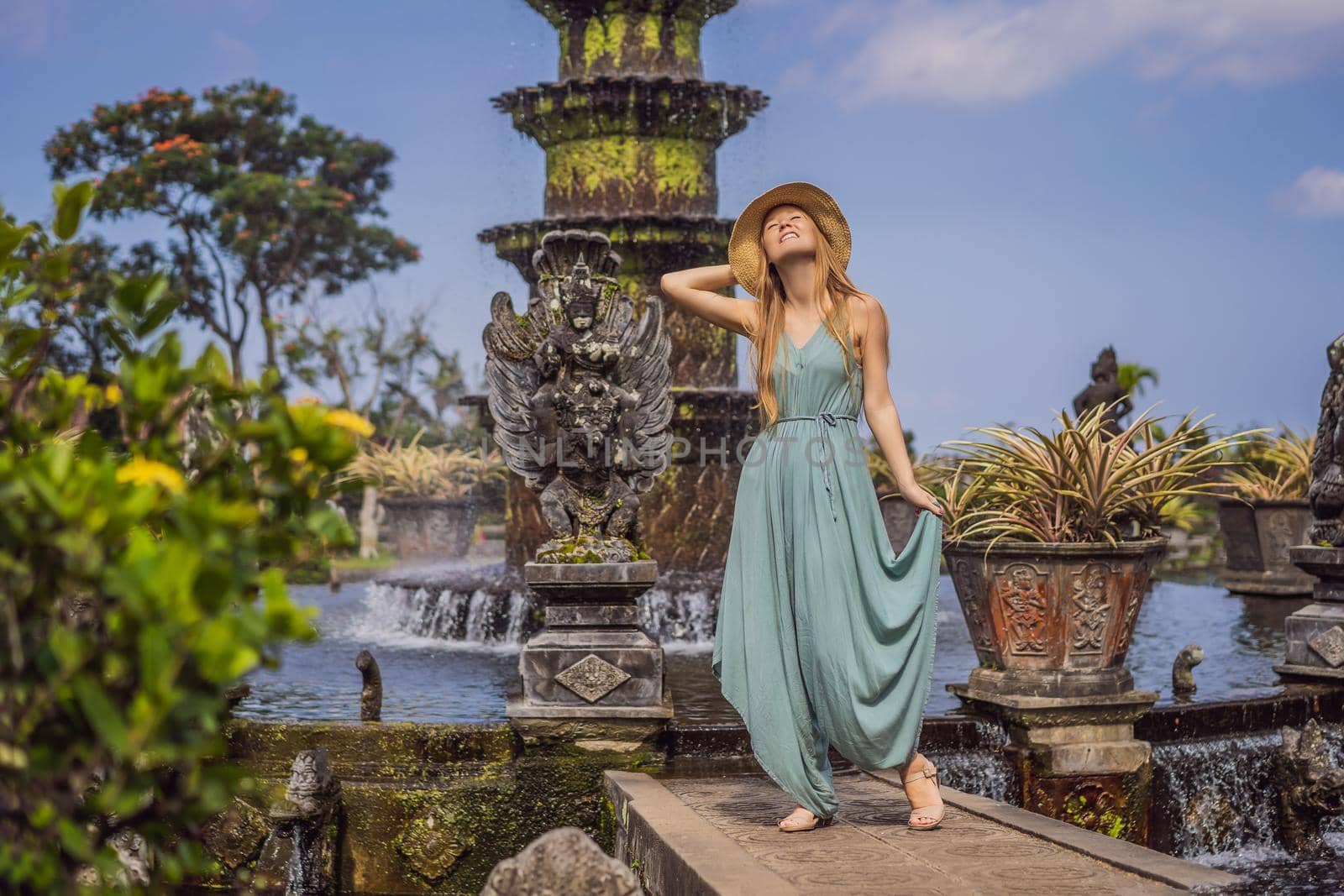 Young woman tourist in Taman Tirtagangga, Water palace, Water park, Bali Indonesia.