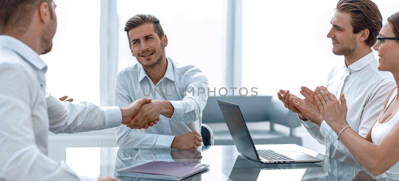 handshake business partners over the Desk.the concept of cooperation