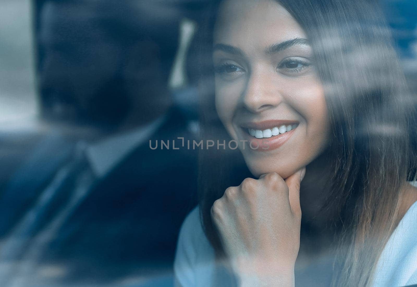 woman sitting in a moving car, looking through her window towards