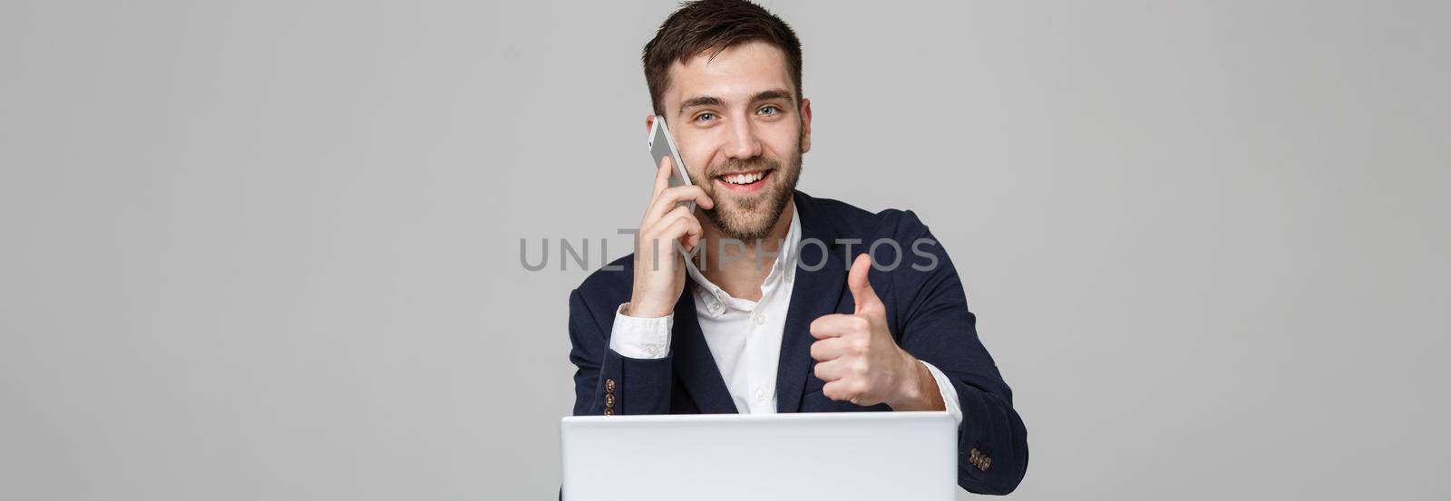 Business Concept - Portrait Handsome Business man showing thump up and smiling confident face in front of his laptop. White Background.Copy Space. by Benzoix