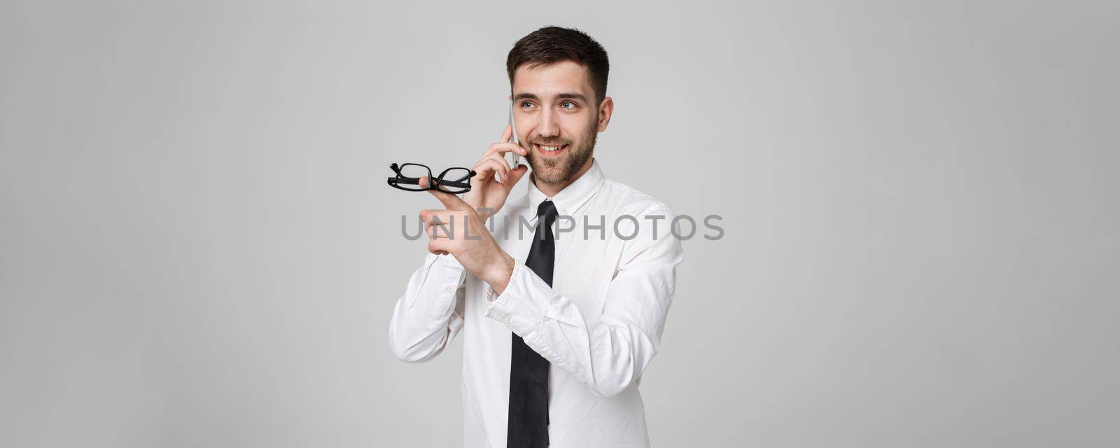 Lifestyle and Business Concept - Portrait of a handsome businessman enjoy talking with mobile phone. Isolated White background. Copy Space. by Benzoix