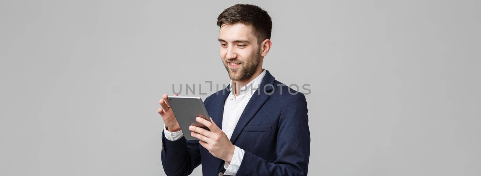 Business Concept - Portrait Handsome Business man playing digital tablet with smiling confident face. White Background.Copy Space.