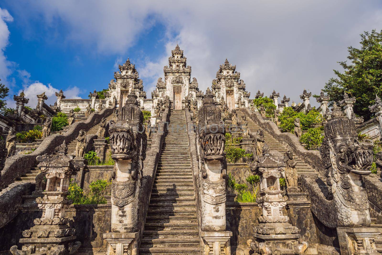 Three stone ladders in beautiful Pura Lempuyang Luhur temple. Summer landscape with stairs to temple. Paduraksa portals marking entrance to middle sanctum jaba tengah of Pura Penataran Agung, Bali.