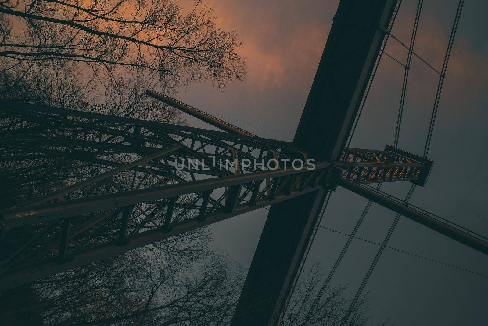 Landscape of a pedestrian bridge in the evening at sunset. Beautiful park landscape with photo filter