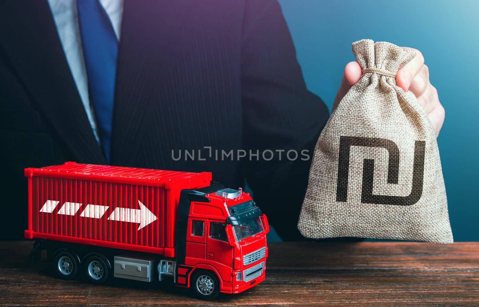 Businessman with israeli shekel money bag and truck. Good salaries for drivers. Rising prices, global containers shortage. Logistics. High income of the transport business and the transport of goods.