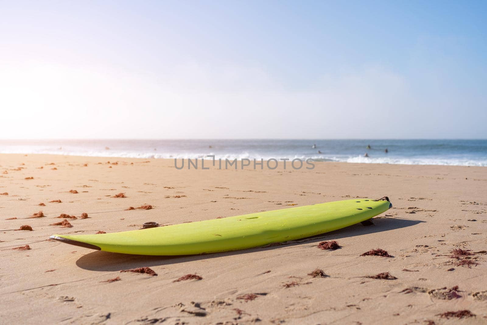 Serf board on the beach. View of nice Atlantic ocean beach with sand ,blue sea and blue sky. Holiday and vacation concept. Portugal Carcavelos