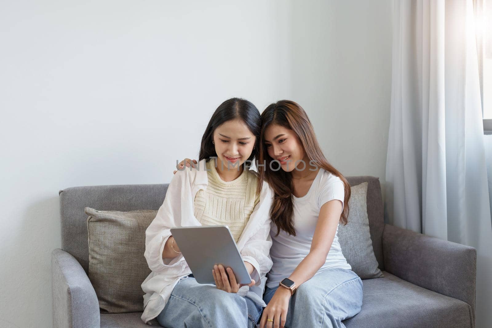 lgbtq, lgbt concept, homosexuality, portrait of two asian women enjoying together and showing love for each other while using tablet.