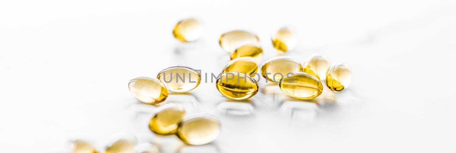 Vitamin D and golden Omega 3 pills for healthy diet nutrition, fish oil food supplement pill capsules, healthcare and medicine as pharmacy background by Anneleven