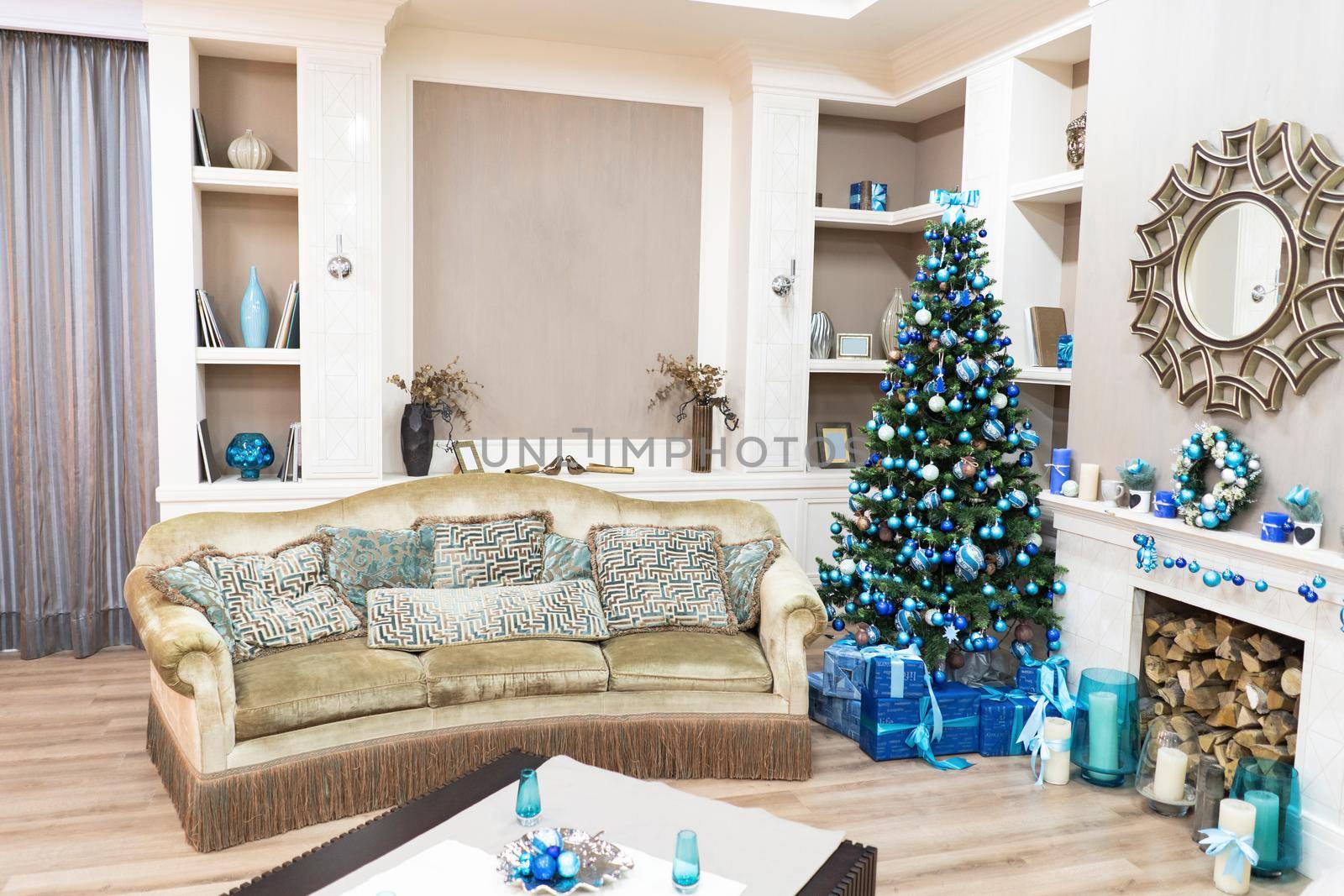 Beautiful New Year Interior with Christmas Tree in Corner. Couch with Pillows and Green Christmas Tree with Beautiful Presents. Sweet Home Comfort by LipikStockMedia