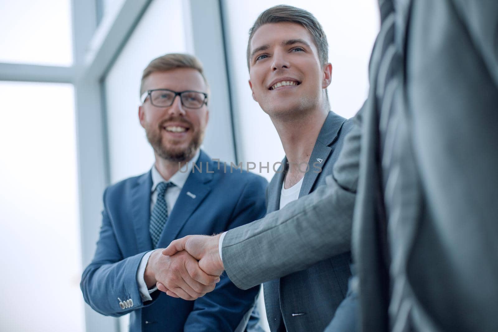 close up. smiling business colleagues shaking hands . business concept