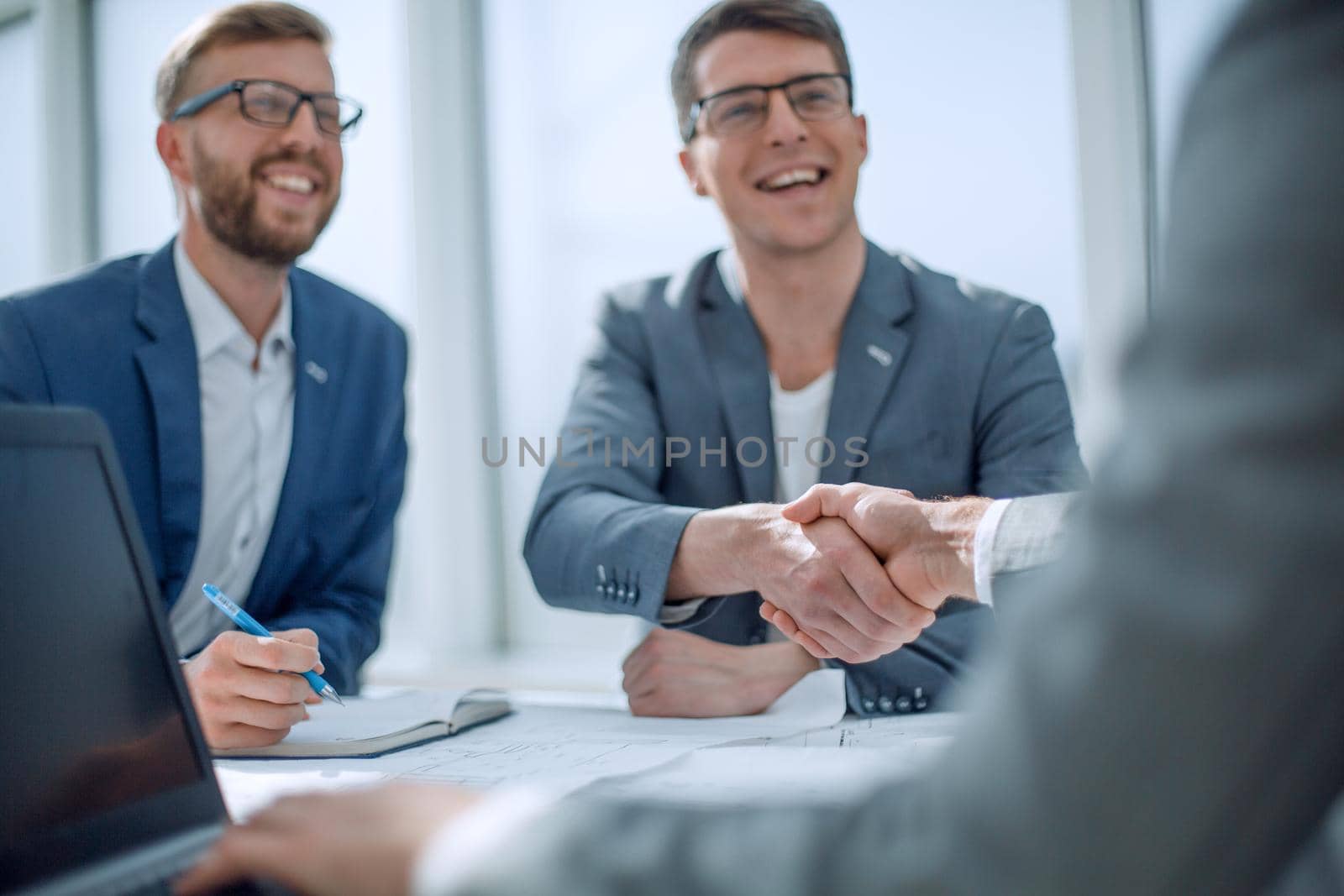 close up. business partners shaking hands at a meeting . concept of cooperation
