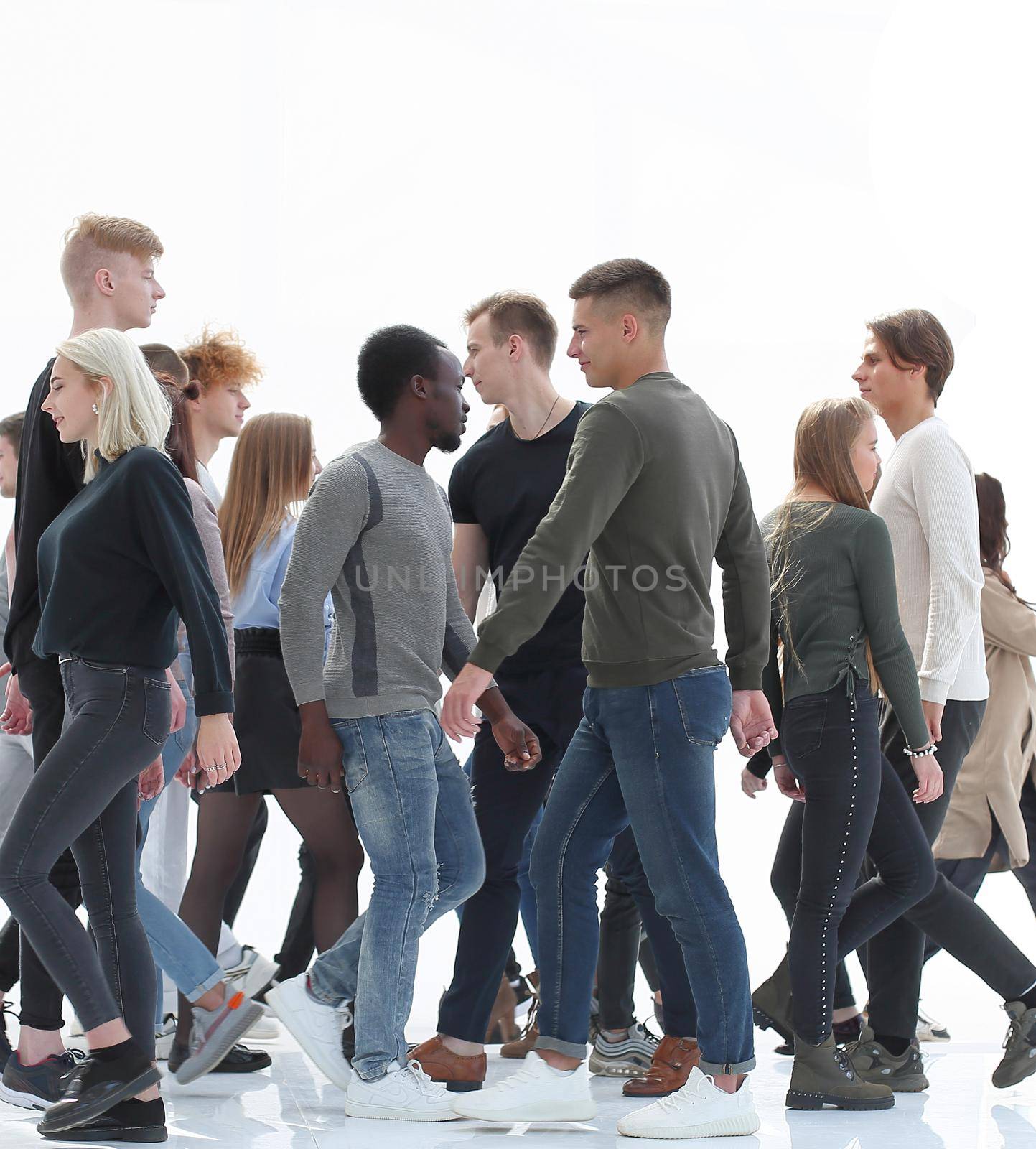 in full growth. diverse young people walking in different directions. photo with copy space