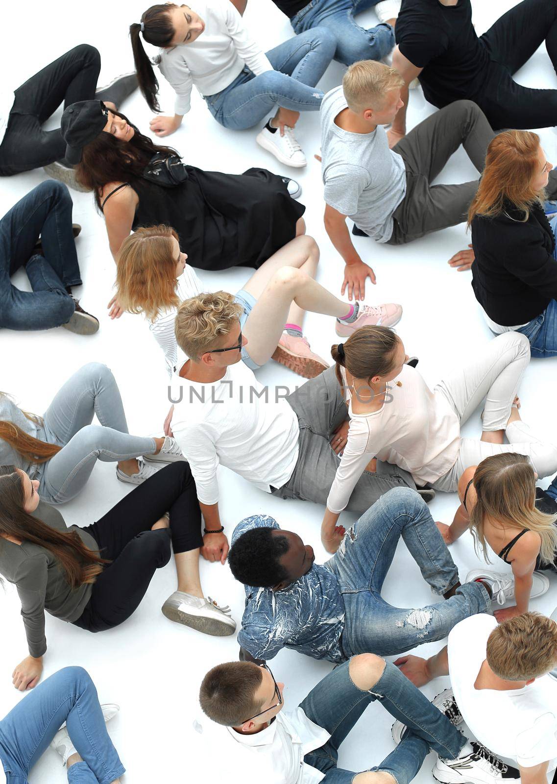 top view. large casual group of young people sitting on the floor.