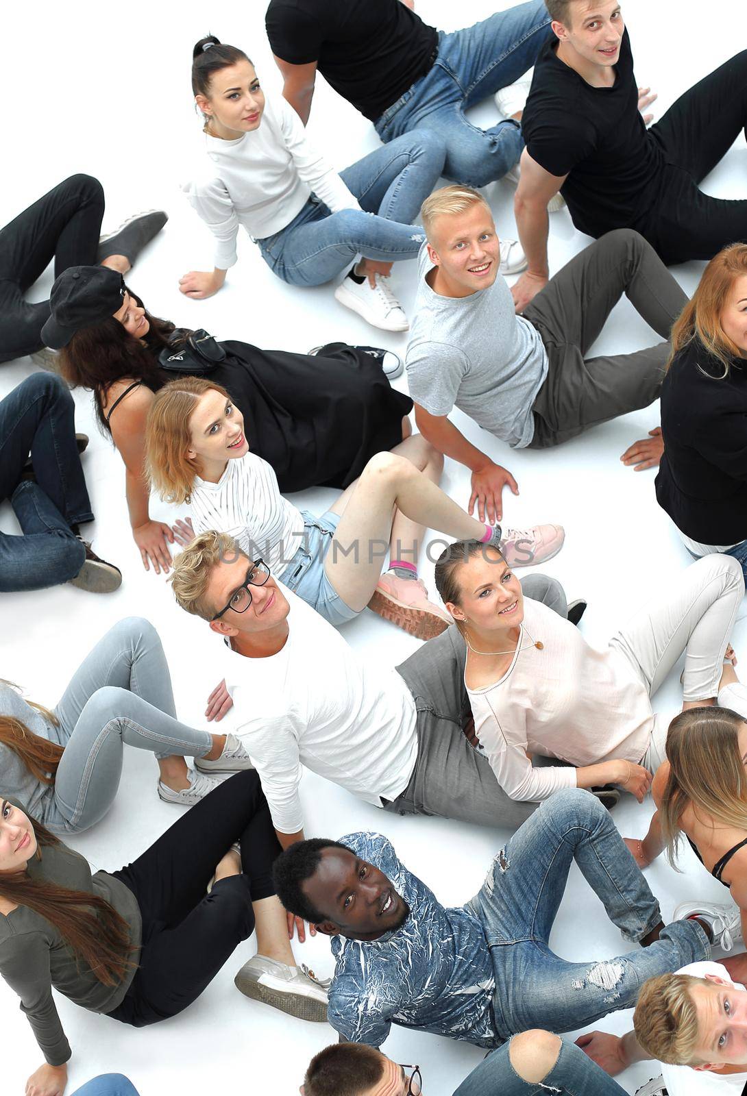 group of young people sitting on the floor and looking at the camera. by asdf