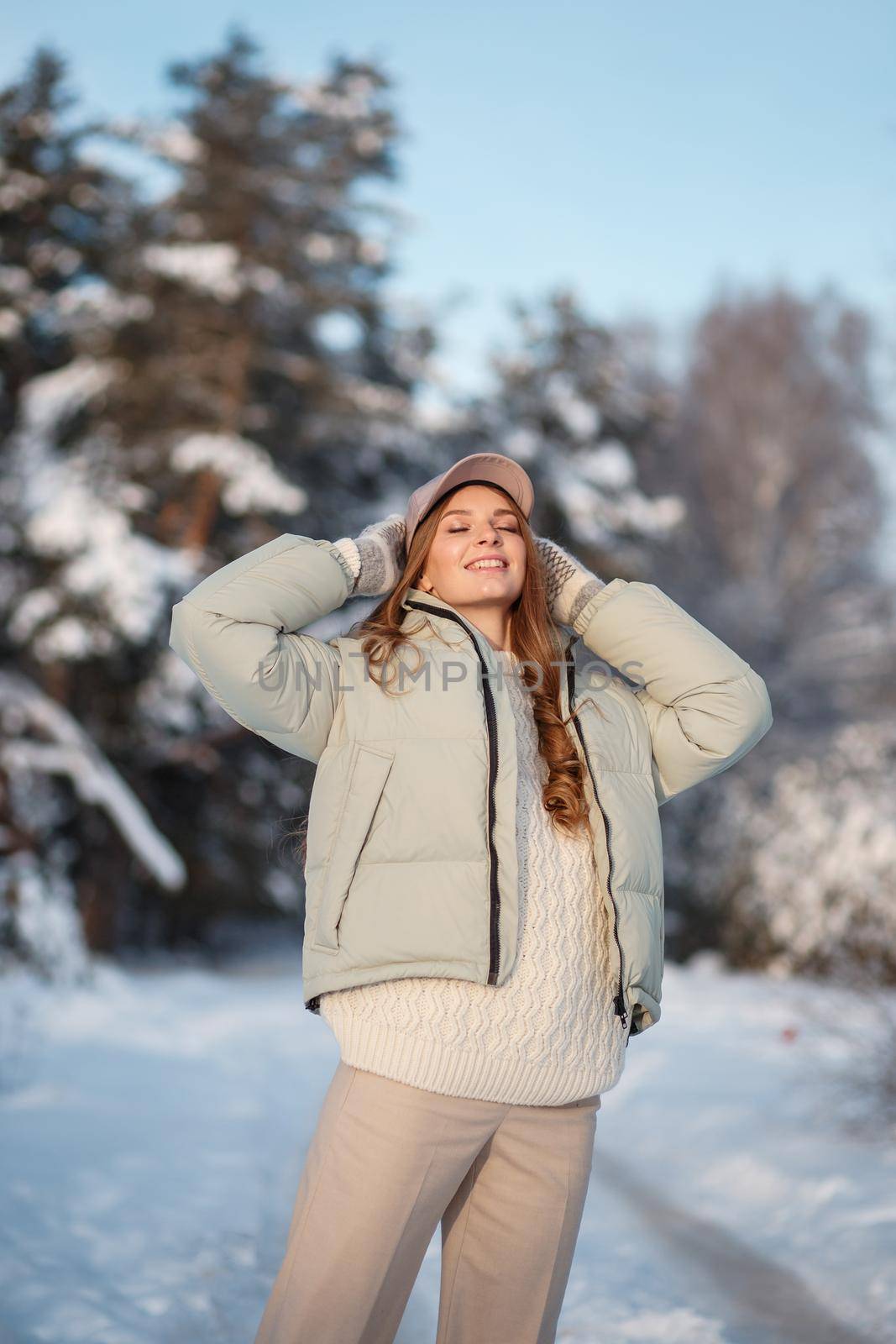 A model girl walking through a snow-covered forest