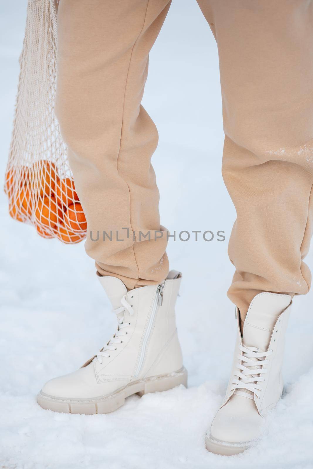 The model demonstrates women's shoes in the snow