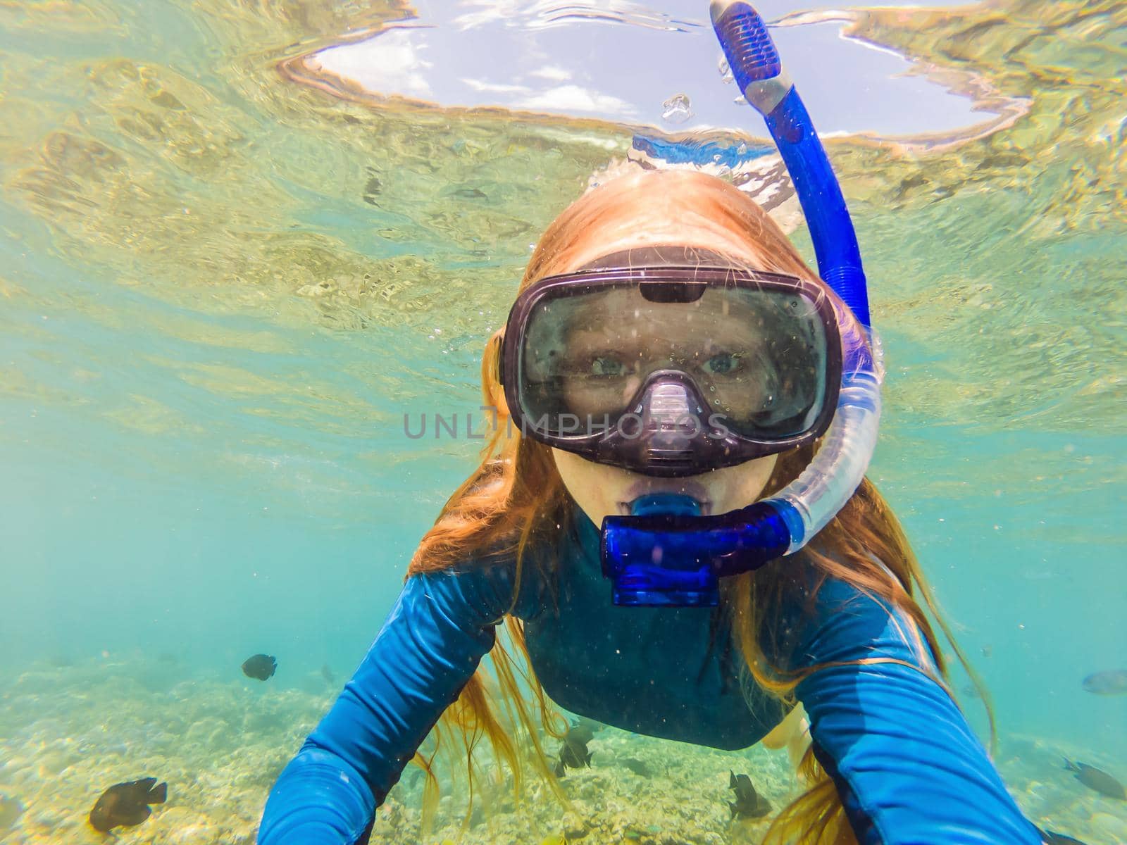 Happy woman in snorkeling mask dive underwater with tropical fishes in coral reef sea pool. Travel lifestyle, water sport outdoor adventure, swimming lessons on summer beach holiday by galitskaya