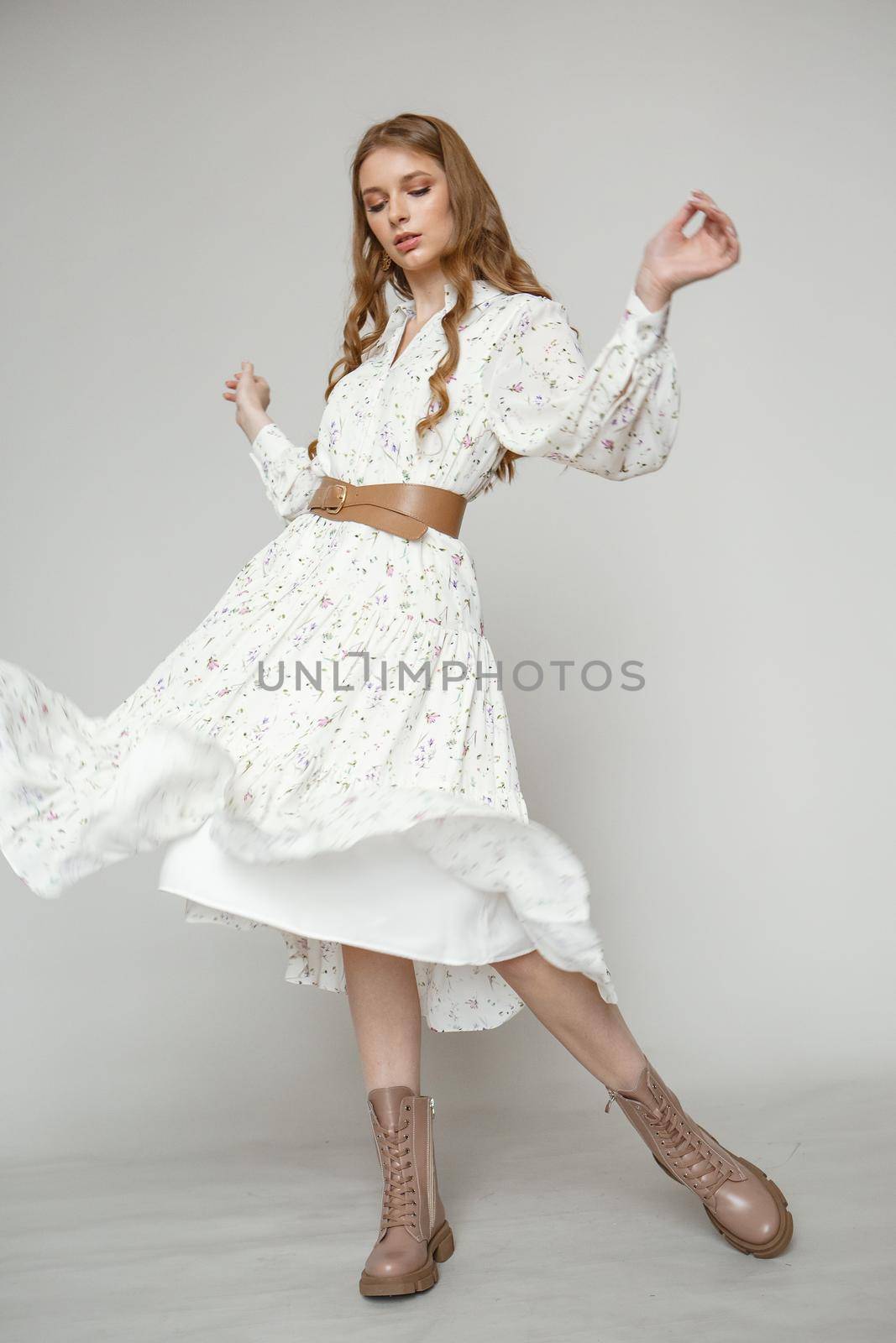 beautiful young girl in flying white dress. Flowing fabric.