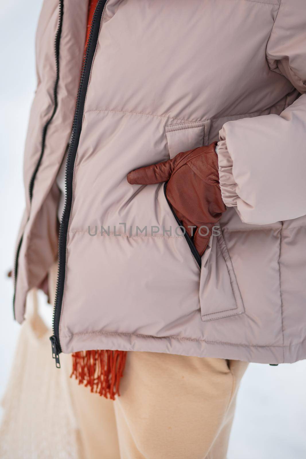 A girl in a winter jacket, a hand in a camran by deandy
