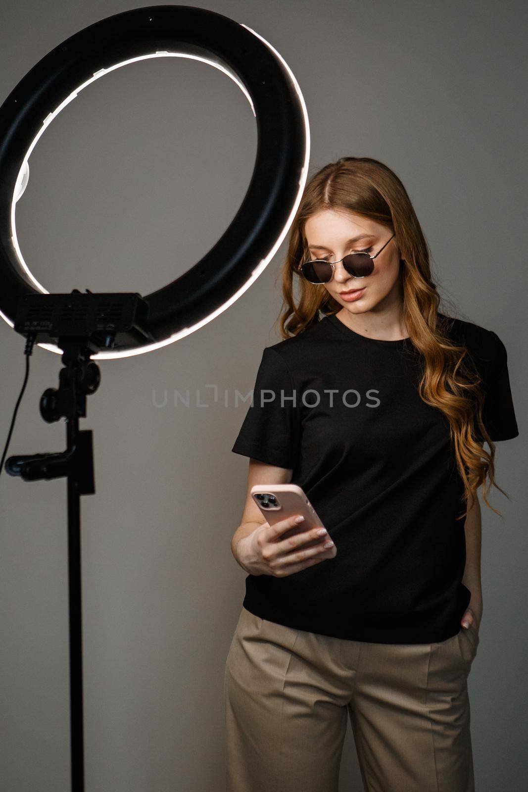 A model in casual clothes on a studio background. Shooting fashion clothes