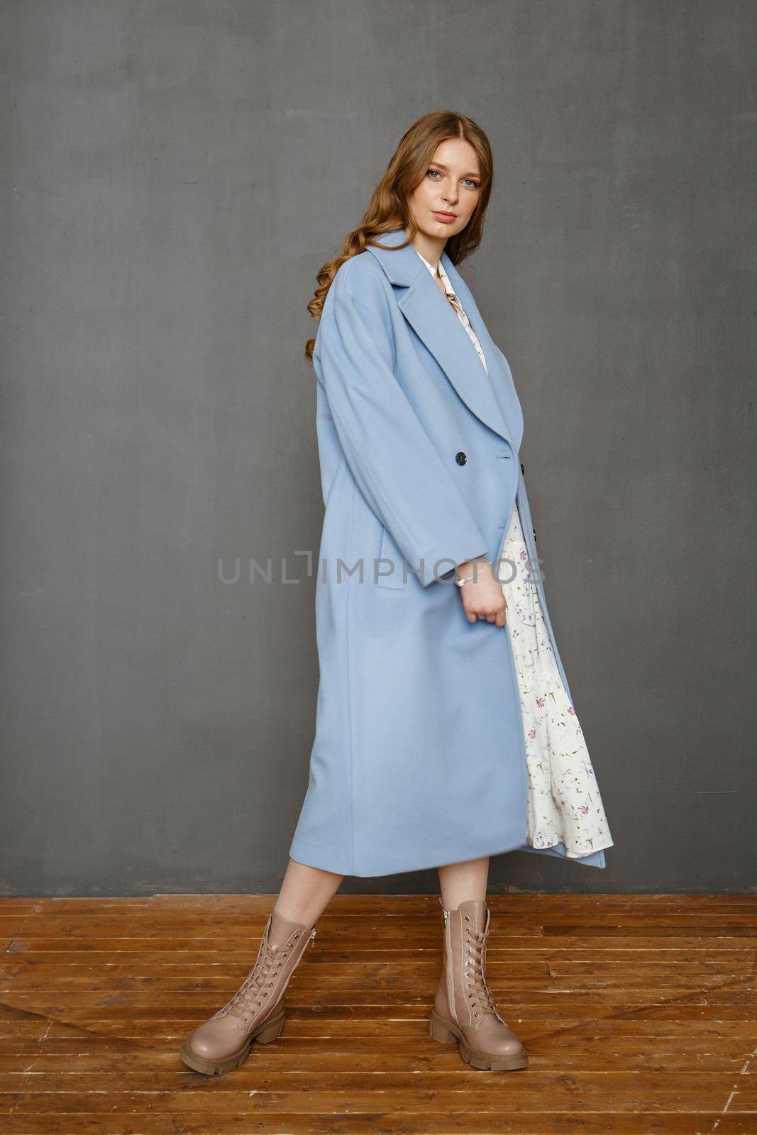 Beautiful brunette woman in a blue coat and nice top. Fashion winter photo