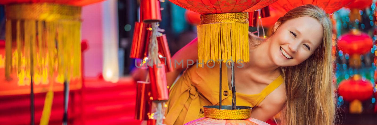 Woman celebrate Chinese New Year look at Chinese red lanterns. Chinese lanterns BANNER, LONG FORMAT by galitskaya