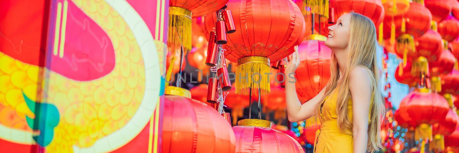 Woman celebrate Chinese New Year look at Chinese red lanterns. Chinese lanterns. BANNER, LONG FORMAT