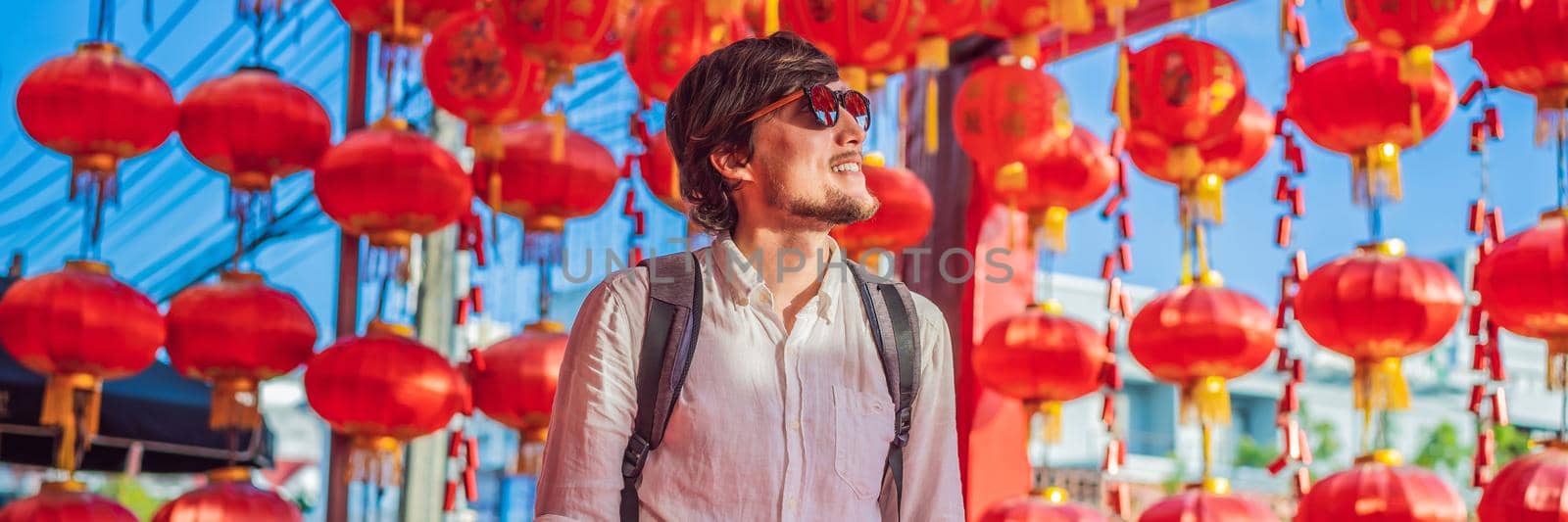 Man celebrate Chinese New Year look at Chinese red lanterns. Chinese lanterns. BANNER, LONG FORMAT