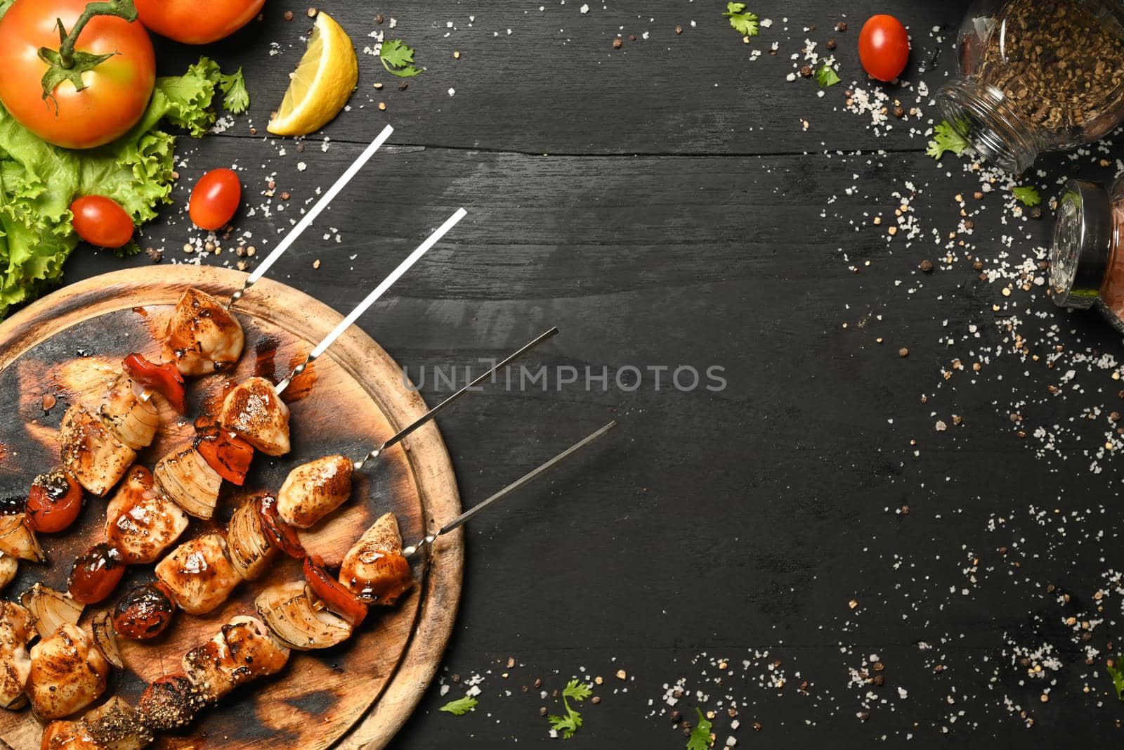 Grilled meat and vegetables on wooden background. Top view with copy space.