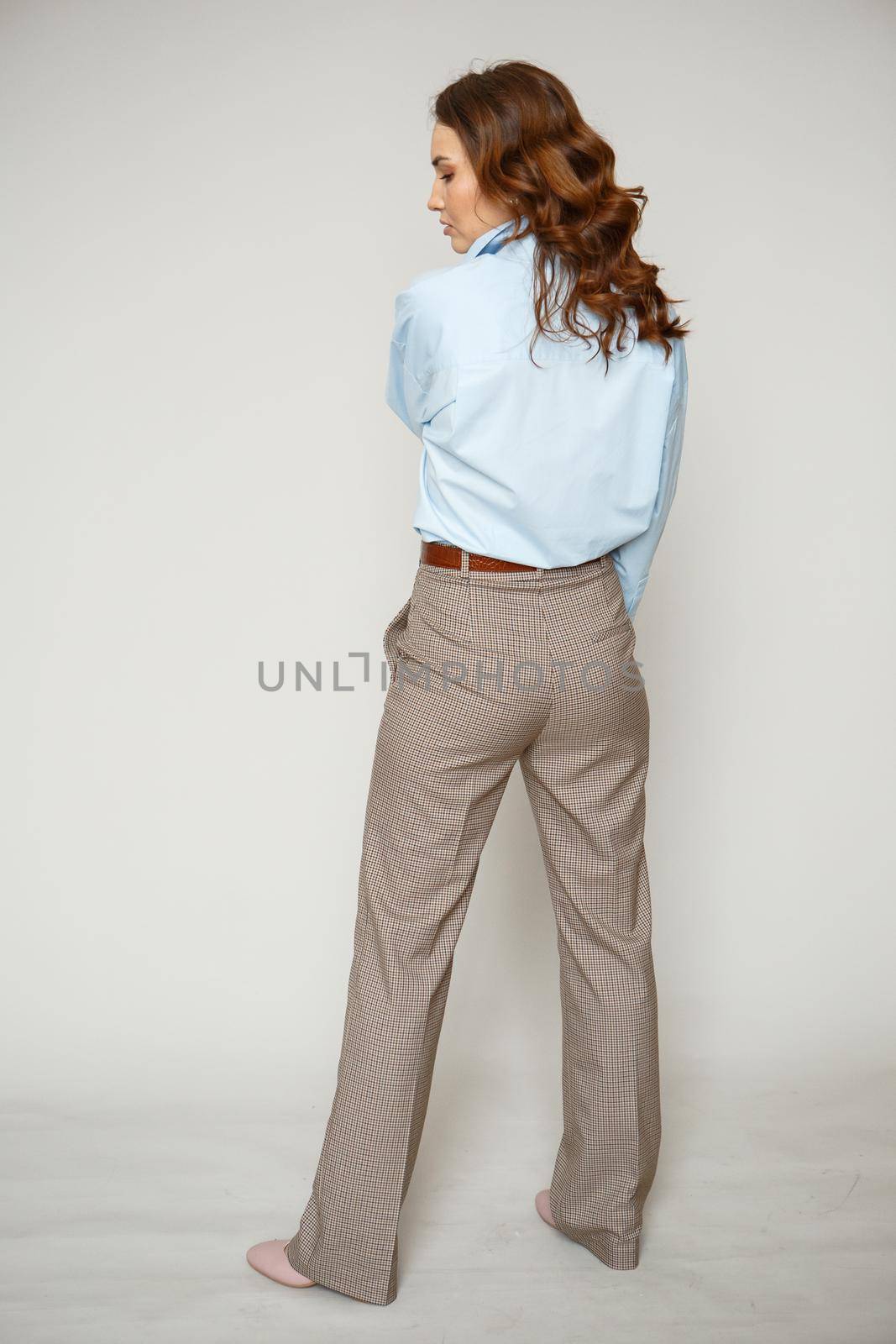 A girl in a blue shirt and trousers. Shooting fashion clothes by deandy
