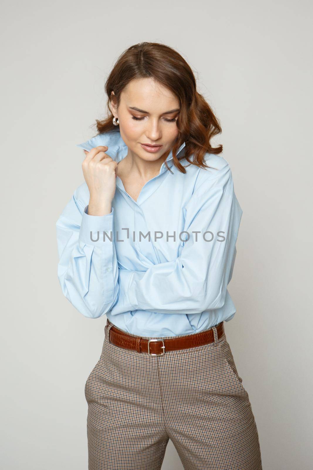 A girl in a blue shirt and trousers. Shooting fashion clothes by deandy