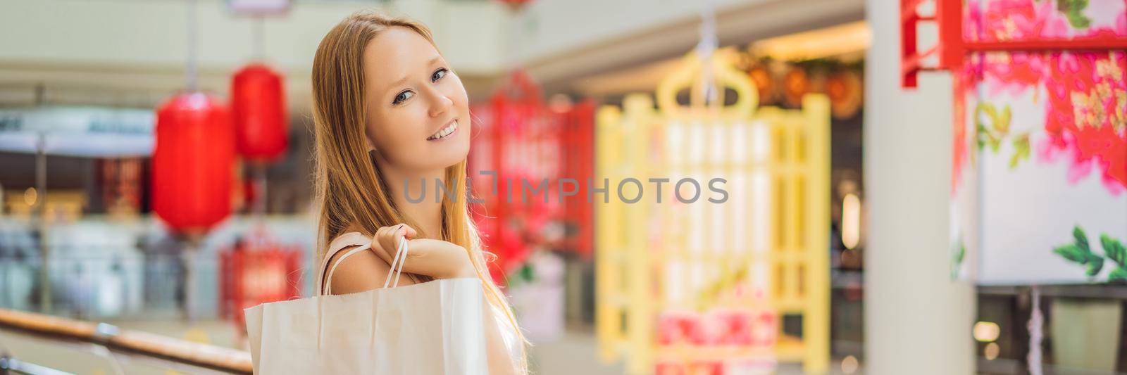 BANNER, LONG FORMAT Woman hold shopping bag against the background of Chinese red lanterns for the Chinese New Year. Big sale in honor of the New Year's Eve. Black Chinese Friday 11.11.