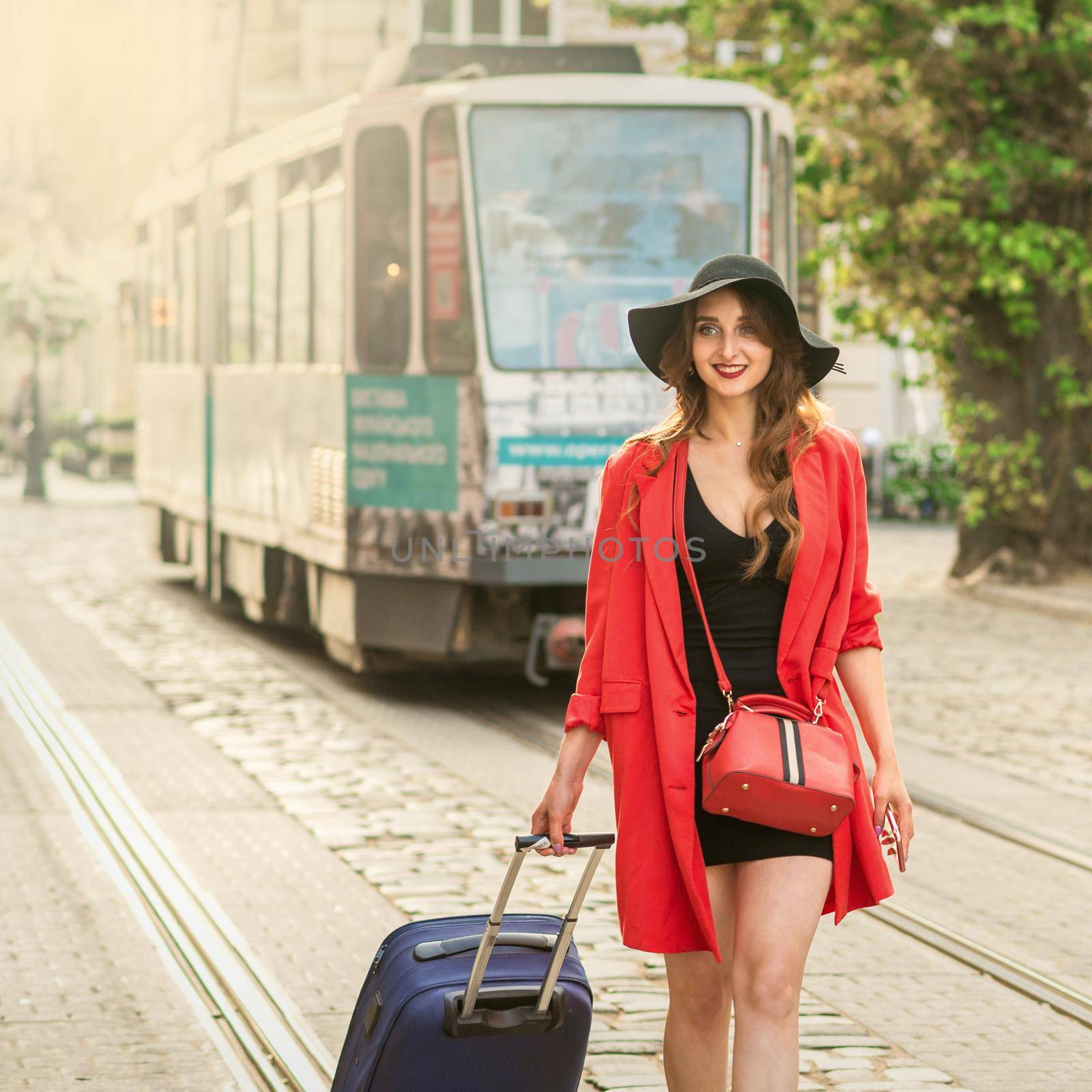Tourist young woman traveling on the tram track road of the old city street.