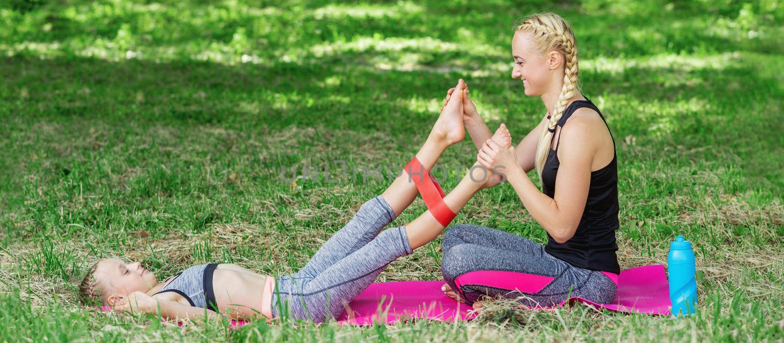 Mom trains daughter's legs by fitness gum by okskukuruza
