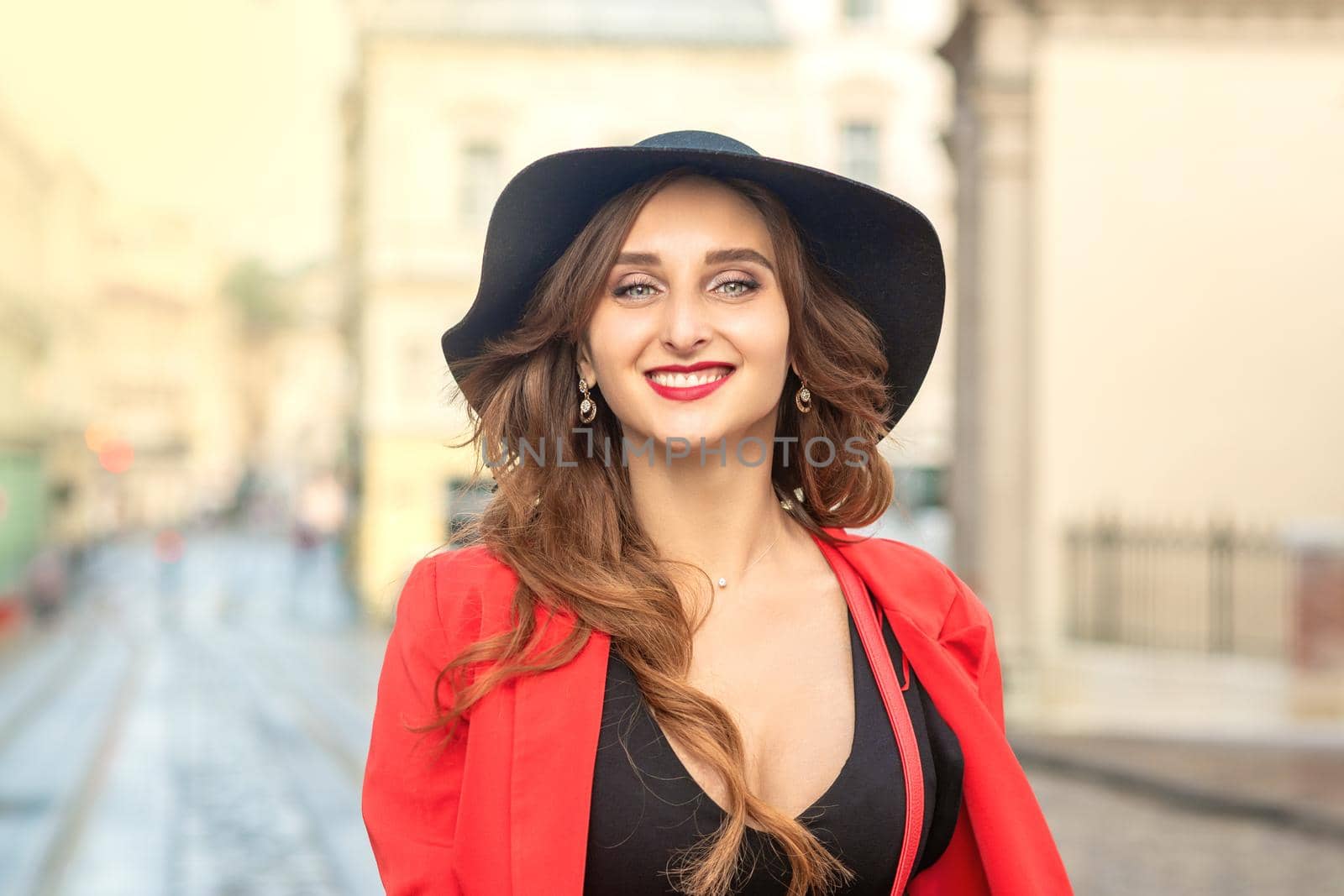 Close up portrait of fashionable young pretty girl wearing hat posing at the city in Europe.