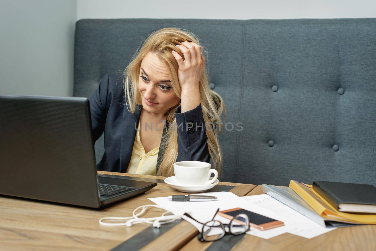 Dissatisfied surprised caucasian young woman look at laptop screen in the home office.