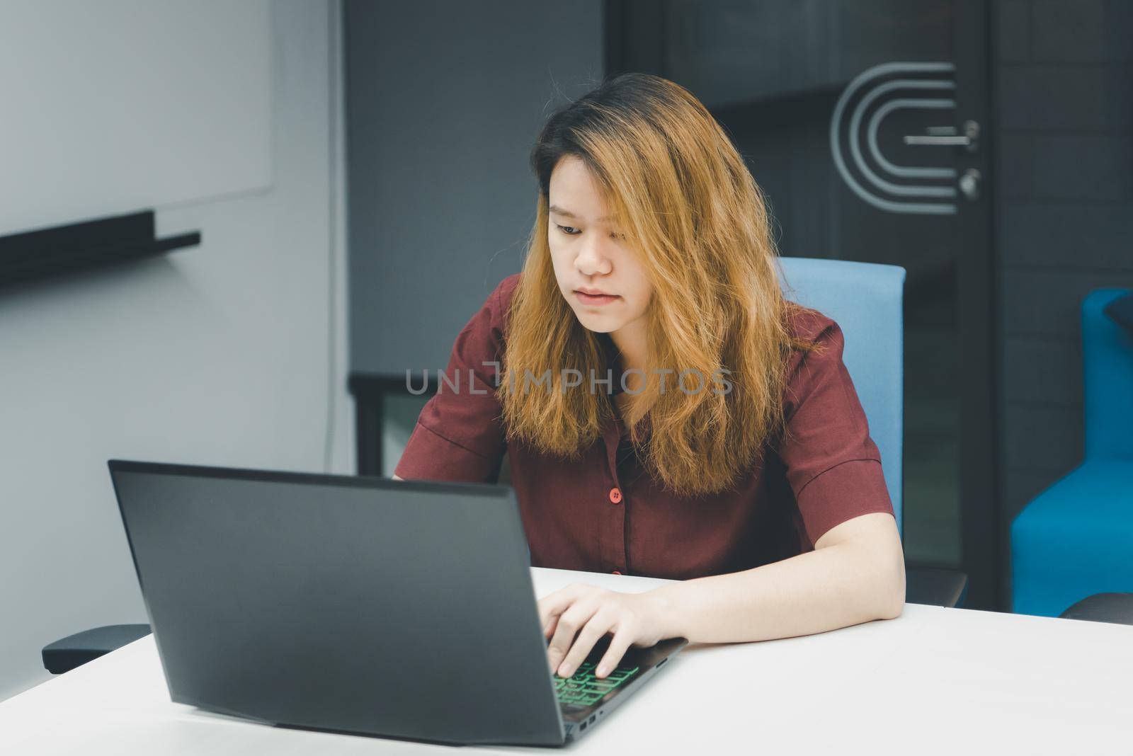 Woman working by laptop in office with thinking by PongMoji