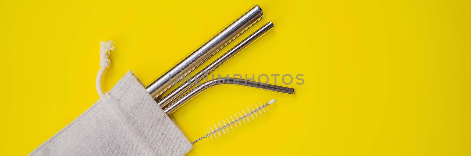 Steel drinking straws on a yellow background. Zero waste concept. BANNER, LONG FORMAT